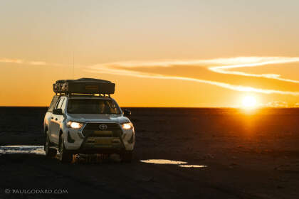 camping car on wet road at sunset