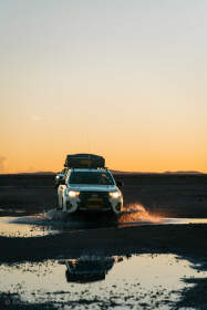 camping car on wet road at sunset