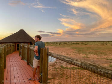 James dstanding on passerelle at sunset