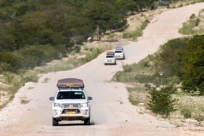 camping cars driving on gravel road