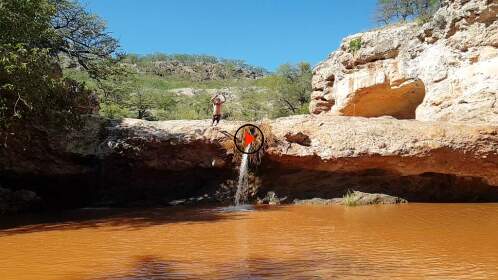 James jumping into waterfall pool