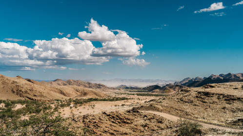 arid valley & hills under clouds