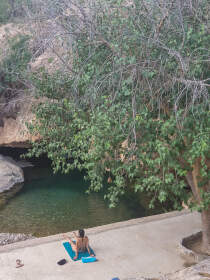 Naomi relaxing near hot spring rock pool