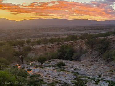 river & rocky hills at sunset
