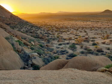 plain with granite rocks at sunrise