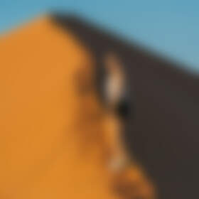 Manon walking on sand dune
