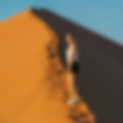 Manon walking on sand dune