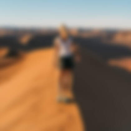 Manon walking on sand dune