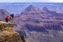 Men on platform looking inside canyon