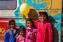 beduin girls with ballon in front Africa map on landy (L)