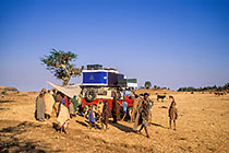 people around landy (FR) with tent in field campsite