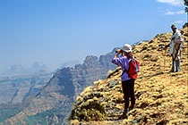 Petra looking through binoculars in front of Felasha ridge