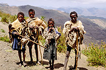 4 children with goat skin standing on piste
