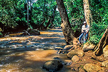 Paul with tripod & camera on side of Thika river