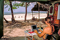 Paul working on computer + landy (R) + beach & sea
