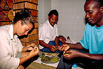 Petra & African guys preparing grasshopers