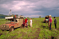 landy (FL) stucked in muddy track in savana + tractor + Petra + Masai people
