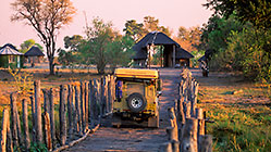 landy(R) driving on wooden bridge to gate