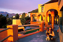 Petra & Jack sitting on deck + brai & patio + pool + mts at sunset