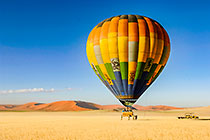 hot air balloon + dunes + grass