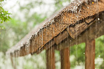 rain falling off tatched roof