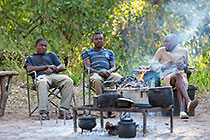 staff at campsite preparing dinner