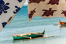 Richelieu-embroidered tablecloths hanging & pirogue