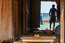 mango on table & man looking at sea