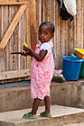 girl with knife eating mango