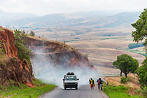 smoking taxi-brousse near people on road