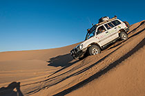 Land Cruiser driving down sand dunes