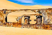 shipwreck in sand along coast