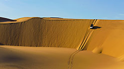 Land Cruiser driving down sand dunes