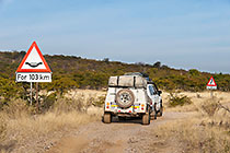 Land Cruiser near road signs