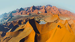 people walking on sand dune