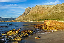 rocks on seashore at sunset
