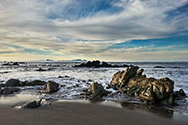 rocks on seashore at sunset