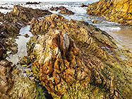 rocks on seashore at sunset