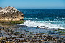 waves on rocky shore & pool