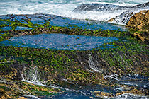 waves on rocky shore & pool