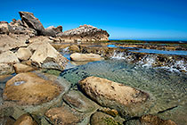 waves on rocky shore & pool