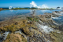waves on rocky shore & pool