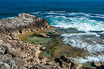 waves on rocky shore & pool