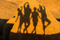 Enya, James, Paul & Petra silhouettes on rock at sunset