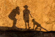 Enya, James, Paul & Petra silhouettes on rock at sunset