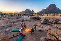 Enya, James, Paul & Petra at campsite with labyrinth | boulders & mountains at sunset