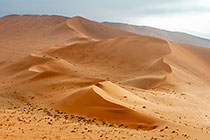 sand dunes under clouds