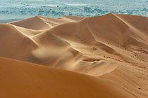 sand dunes under clouds