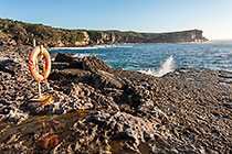 safety bouey on rocky seashore