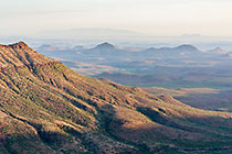 green valleys & mountains at sunset
